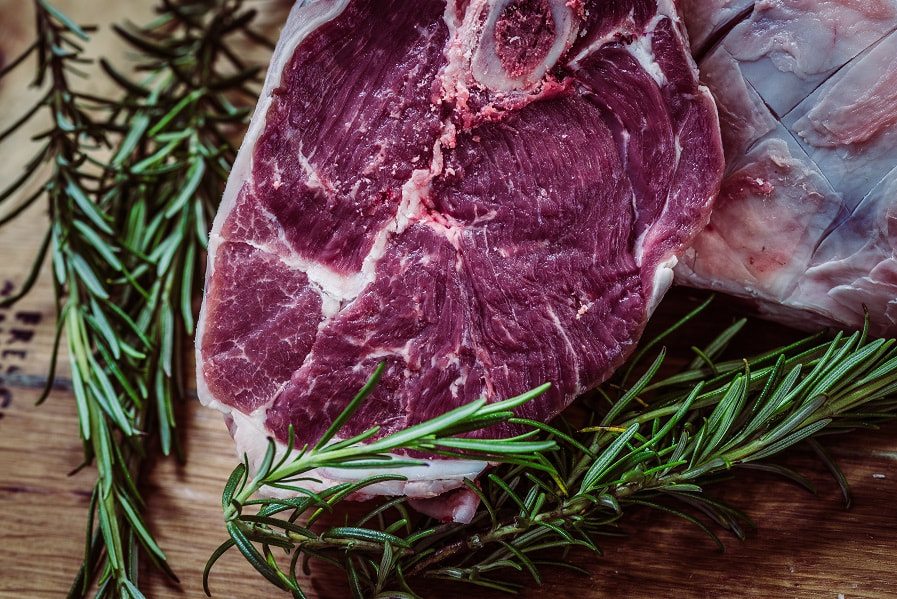 A piece of steak and rosemary. Food price inflation in South Africa declining